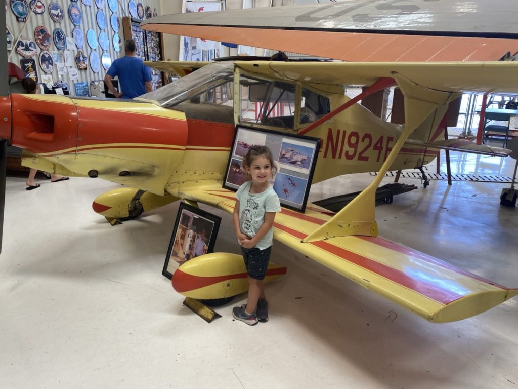 Girls near small airplane at Texas Air and Space Museum